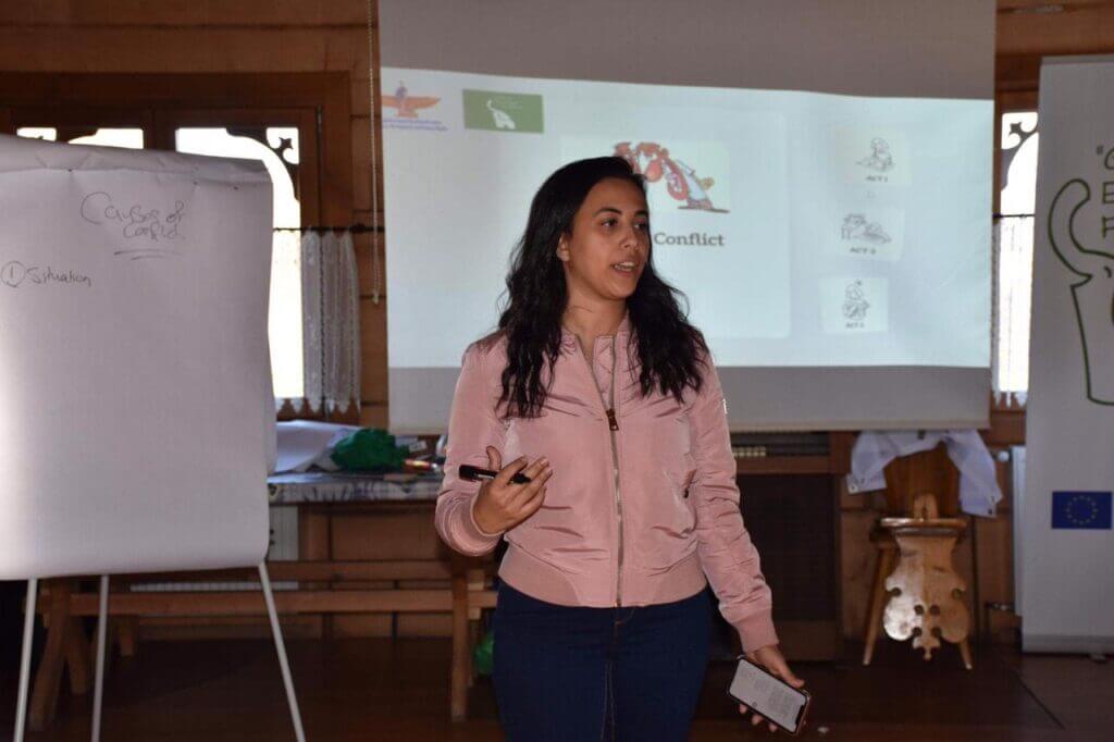 Maat leads a session on peaceful conflict resolution during a training program to combat violence and extremism